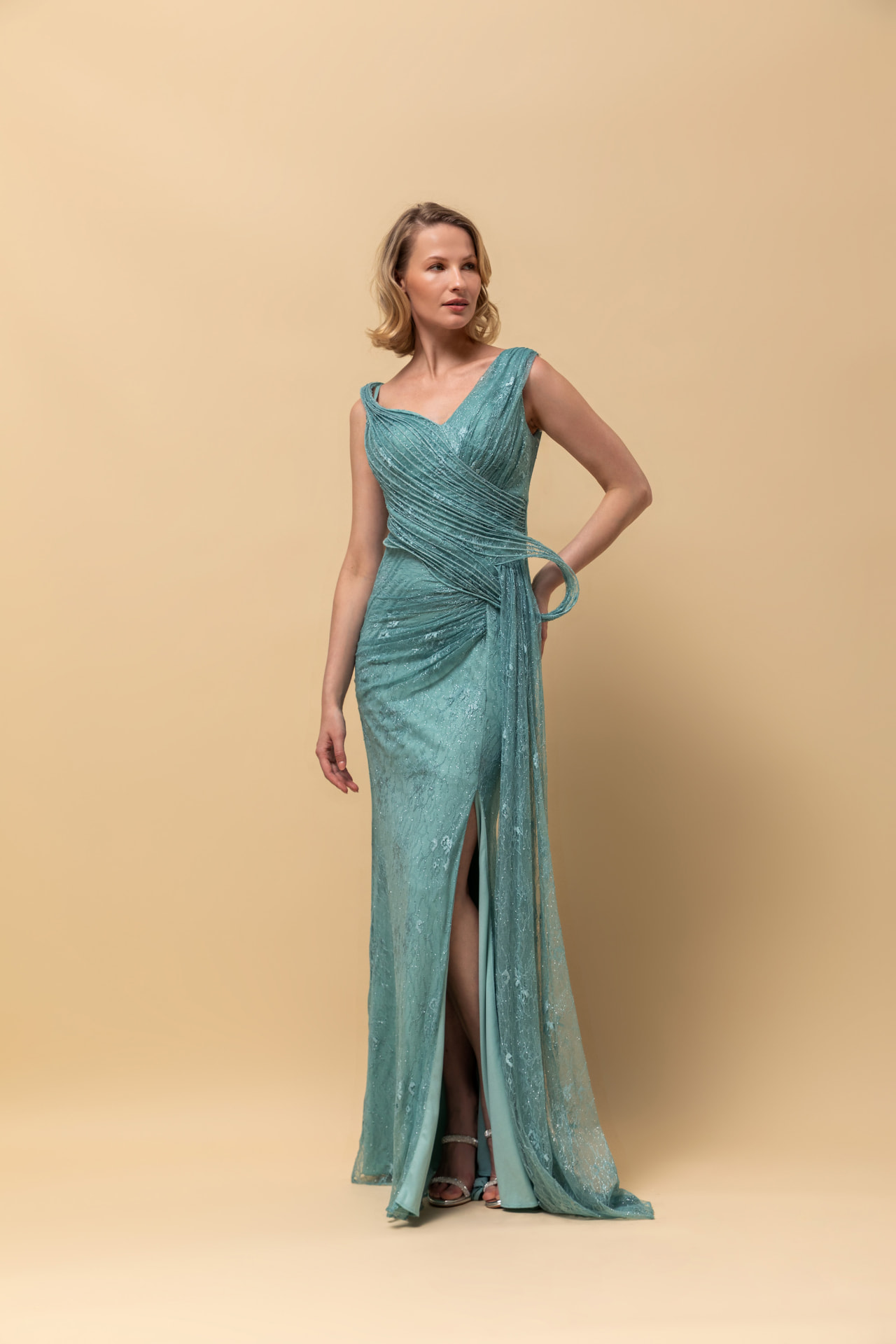 Aqua glitter lace gown with wrapped waist, side drape and high slit
