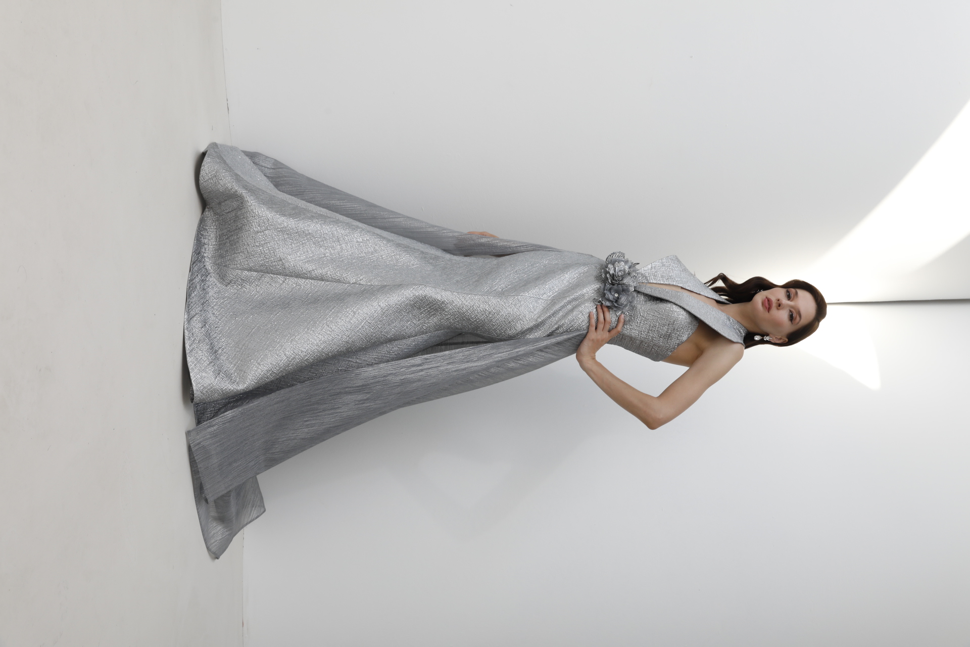 Silver halter-neck mermaid gown with overskirt train and floral waist detail