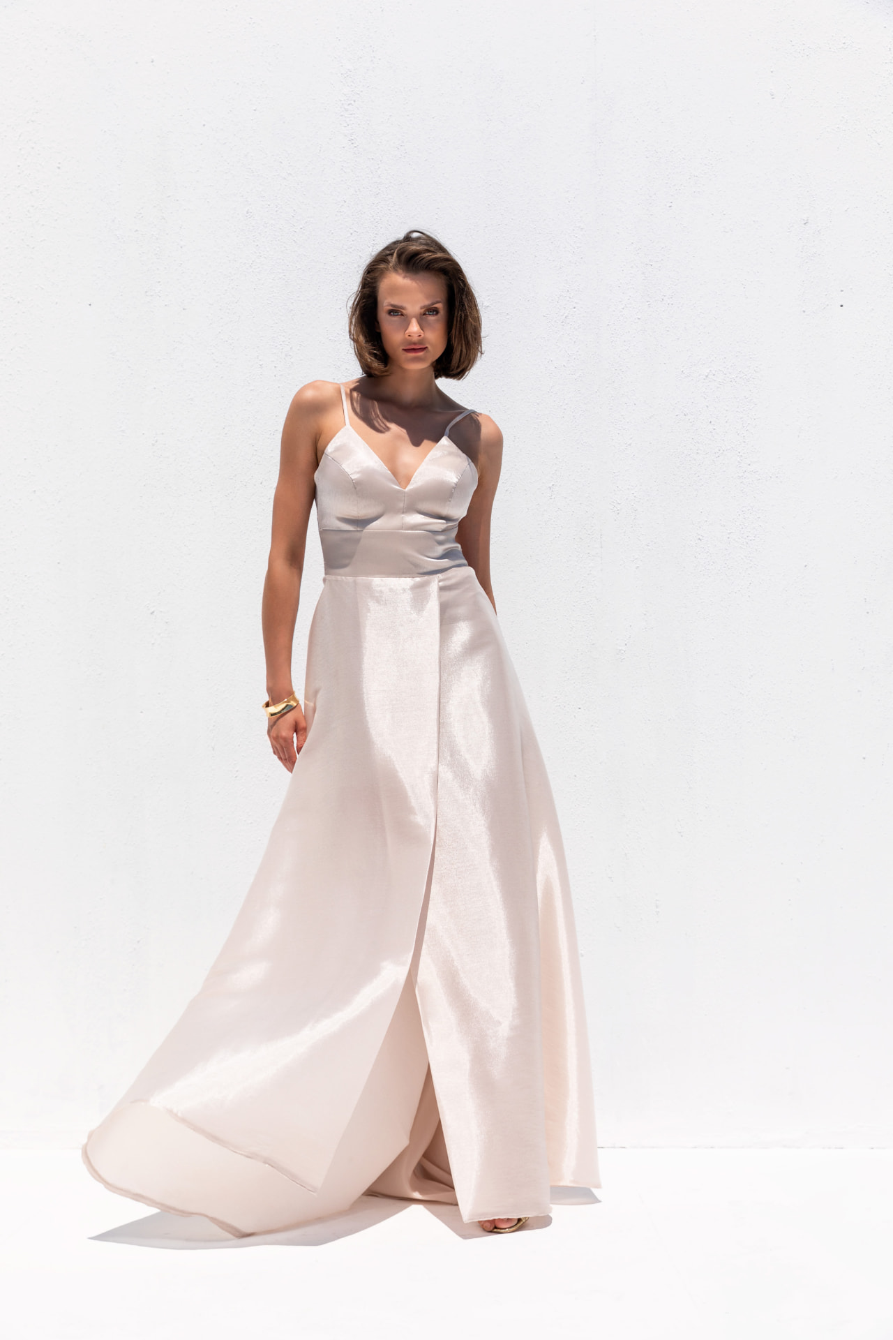Champagne satin V-neck gown with wrap skirt and flowing train