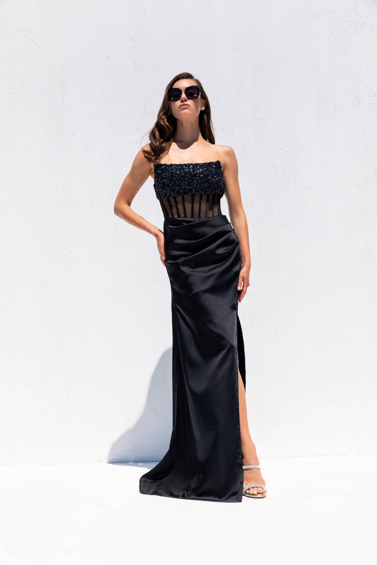 Black beaded corset gown with sheer boned bodice and satin slit skirt